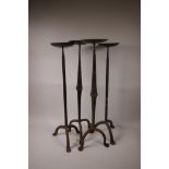 Two pairs of wrought iron pricket candlesticks, 25" high