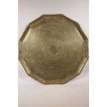 A Persian brass tray engraved with symbols and Arabic script, 23" diameter