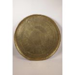 A large Indian brass tray with chased figural and animal decoration, 23" diameter