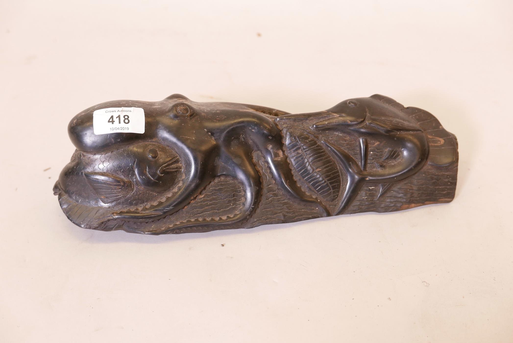 An ebony wood carving of an octopus and swordfish, 13" long