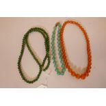 A jade bead necklace, 30" long, a vintage green glass bead necklace and an amber Bakelite necklace