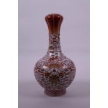 A Chinese red and white porcelain garlic head shaped vase with lotus flower, bat and auspicious