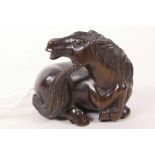 A Japanese carved wood netsuke of a horse, 2" long