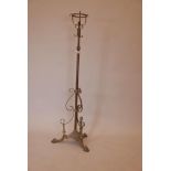 A Victorian brass adjustable oil lamp stand, converted to electricity, 56" x 75" extended
