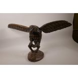 A carved wood figurine of an eagle, 12" high, bears biblical reference, Isaiah 40:31