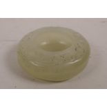 A Chinese green jade water holder with carved scrolling decoration, 2" diameter
