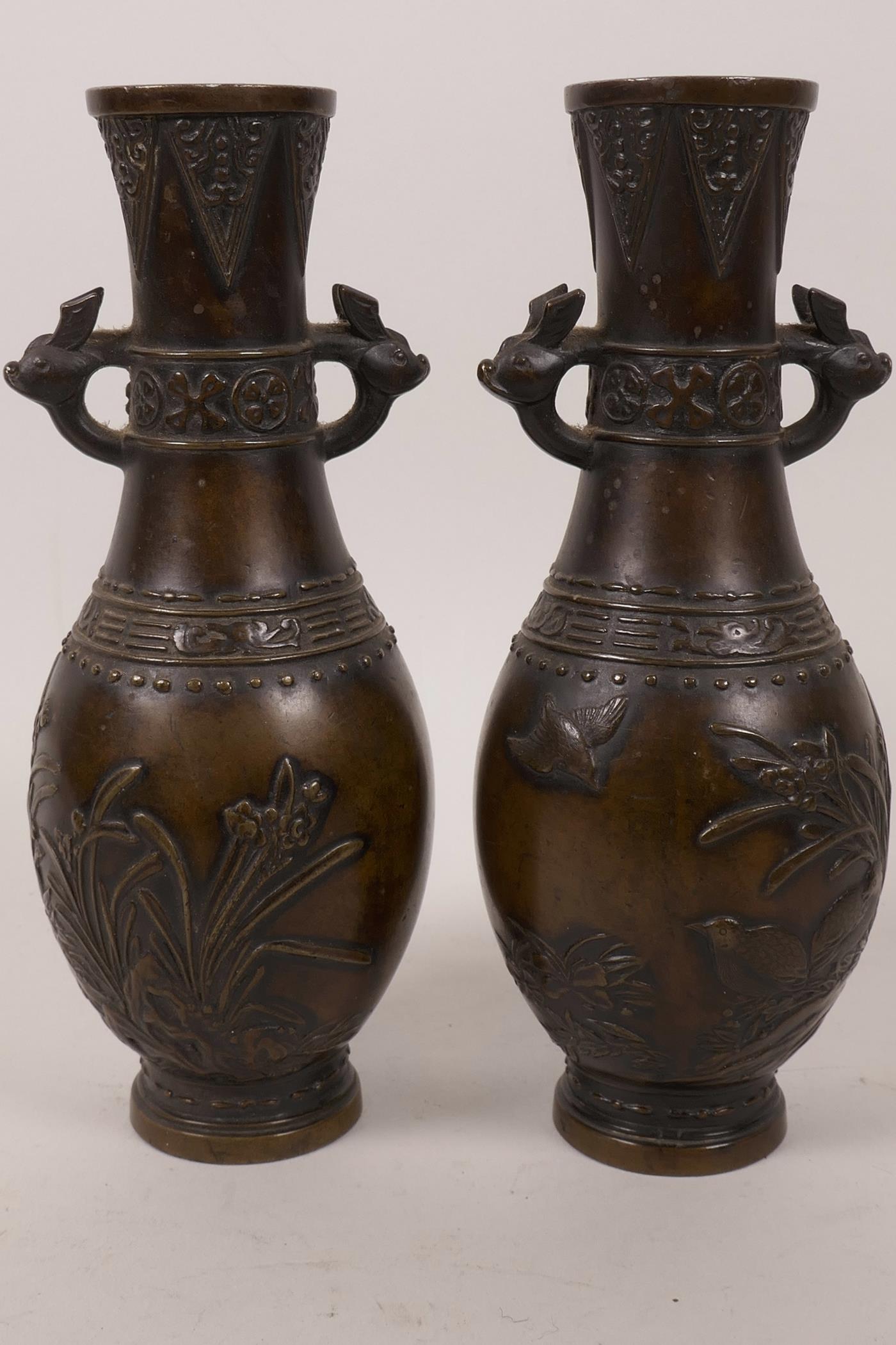 A pair of small Japanese Meiji period bronze specimen vases, the bodies with chased decoration of