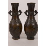 A pair of small Japanese Meiji period bronze specimen vases, the bodies with chased decoration of