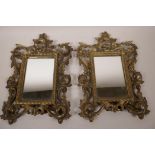 A pair of ornate cast ormolu mirror/picture frames cast as scrolling leaves, 11" x 8" overall