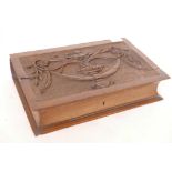 A box in the form of a book, with carved decoration, 15" x 10" x 3½