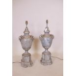 A pair of painted and silver leafed plaster and wood lamps with ram's mask decoration, 28" high