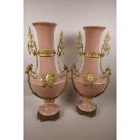 A pair of tall Continental ormolu mounted pink ground porcelain vases, 21½" high
