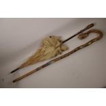 A C19th silk parasol with polished root wood handle, 36" long, A/F, and a hiking stick with