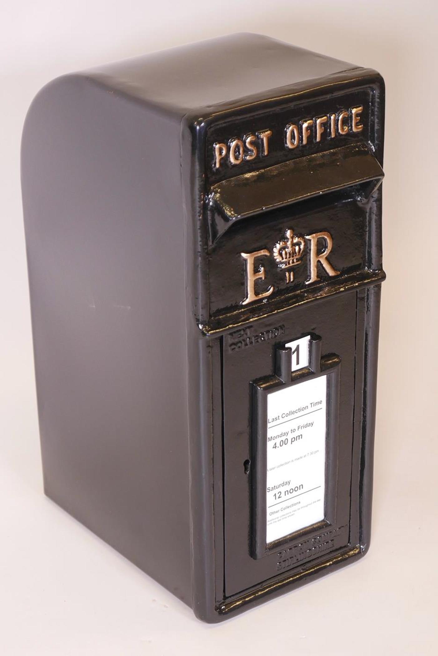 A black metal post box with cast iron front and metal shell, 23" high