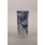 A Chinese blue and white porcelain brush pot decorated with birds and wisteria, seal mark to base,