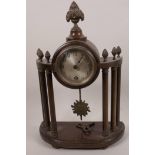 An early C20th French mahogany portico clock, the circular movement raised on six turned columns