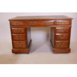 A Victorian oak nine drawer pedestal desk with moulded drawer fronts, brass swan neck handles and