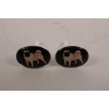 A pair of white metal cufflinks set with cold enamel plaques depicting pugs