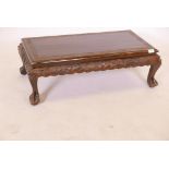 A Chinese teak low table, with carved frieze and top, raised on cabriole supports with paw feet, 33"