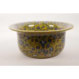 A large Chinese yellow ground pottery bowl with scrolling blue and white floral decoration, 12½"