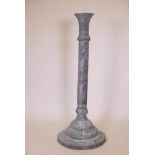 A Middle Eastern copper torchere, with pierced and repoussé decoration depicting processions of