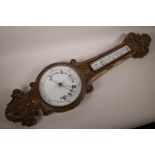 A C19th carved oak cased banjo shaped aneroid barometer with mercury thermometer (glass A/F), 34"