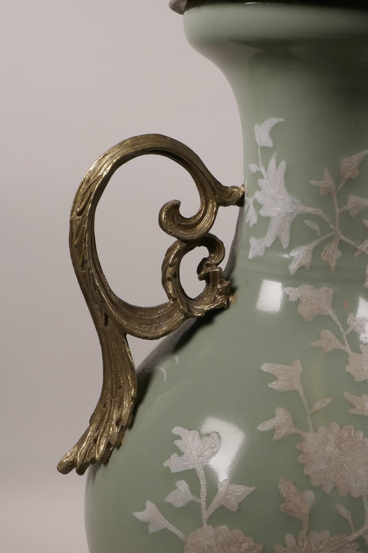 A Chinese celadon ground porcelain vase with later applied ormolu mounts and handles, and white - Image 2 of 6