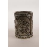 A Chinese white metal brush pot decorated with the emblems of the Eight Immortals, impressed mark to