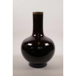 A Chinese pottery bottle vase with a burgundy glaze, 4 character mark to base, 13½" high