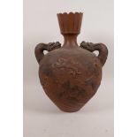 A Japanese Meiji period red earthenware vase of bulbous form with twin dragon handles and chased