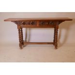 A mahogany side table, with two drawers and carved decoration, raised on twisted supports
