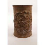 A Chinese bamboo brush pot with carved dragon decoration, 7" high