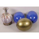 Three painted ostrich eggs and a candlestick made from an anemone shell decorated with coral, 7½"