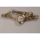 A ladies Accurist 9ct gold cased wristwatch on rolled gold bracelet