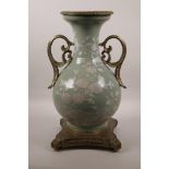 A Chinese celadon ground porcelain vase with later applied ormolu mounts and handles, and white