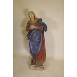 A C19th carved and gessoed pine figure of the Virgin Mary at prayer, 56" high