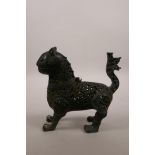 An Indo-Persian pierced bronze censer in the form of a lion, with a hinged head, 7" high x 7" long