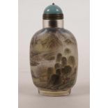 A Chinese reverse painted glass snuff bottle decorated with birds amongst flowers and landscape