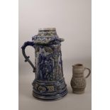 A large German salt glazed stoneware tankard with figural decoration, together with a small grey
