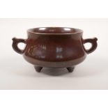 A Chinese rust ground pottery censer with two handles and iridescent splash glaze decoration,