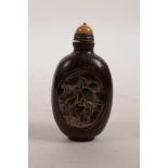 A Chinese horn snuff bottle with carved panels decorated with cranes, 3" high