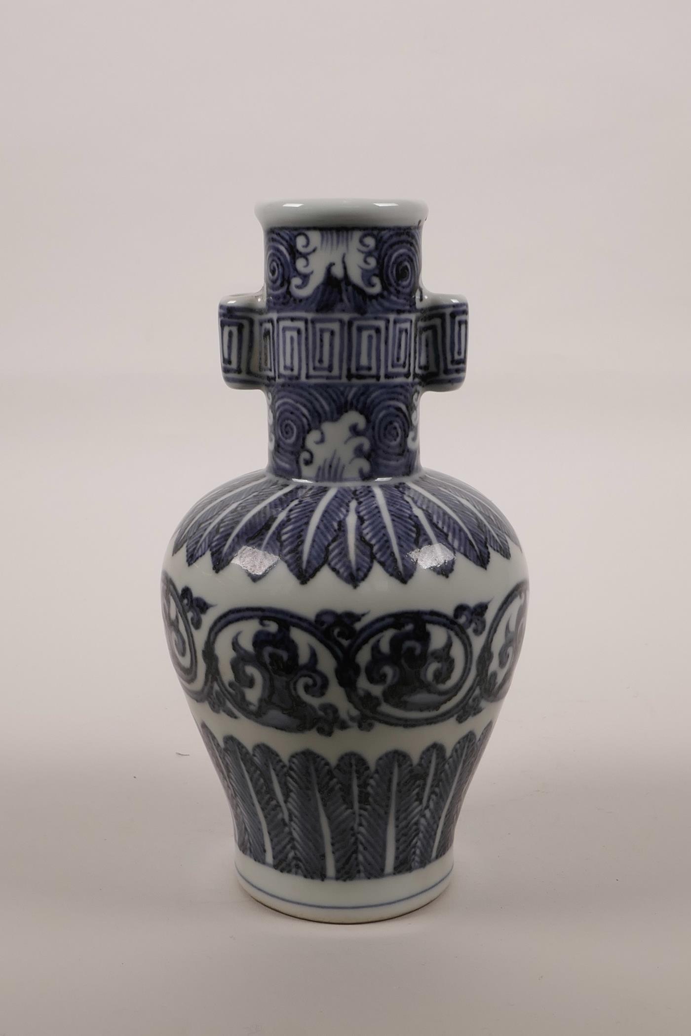 A Chinese blue and white porcelain vase with twin lug handles and scrolling decoration, 6