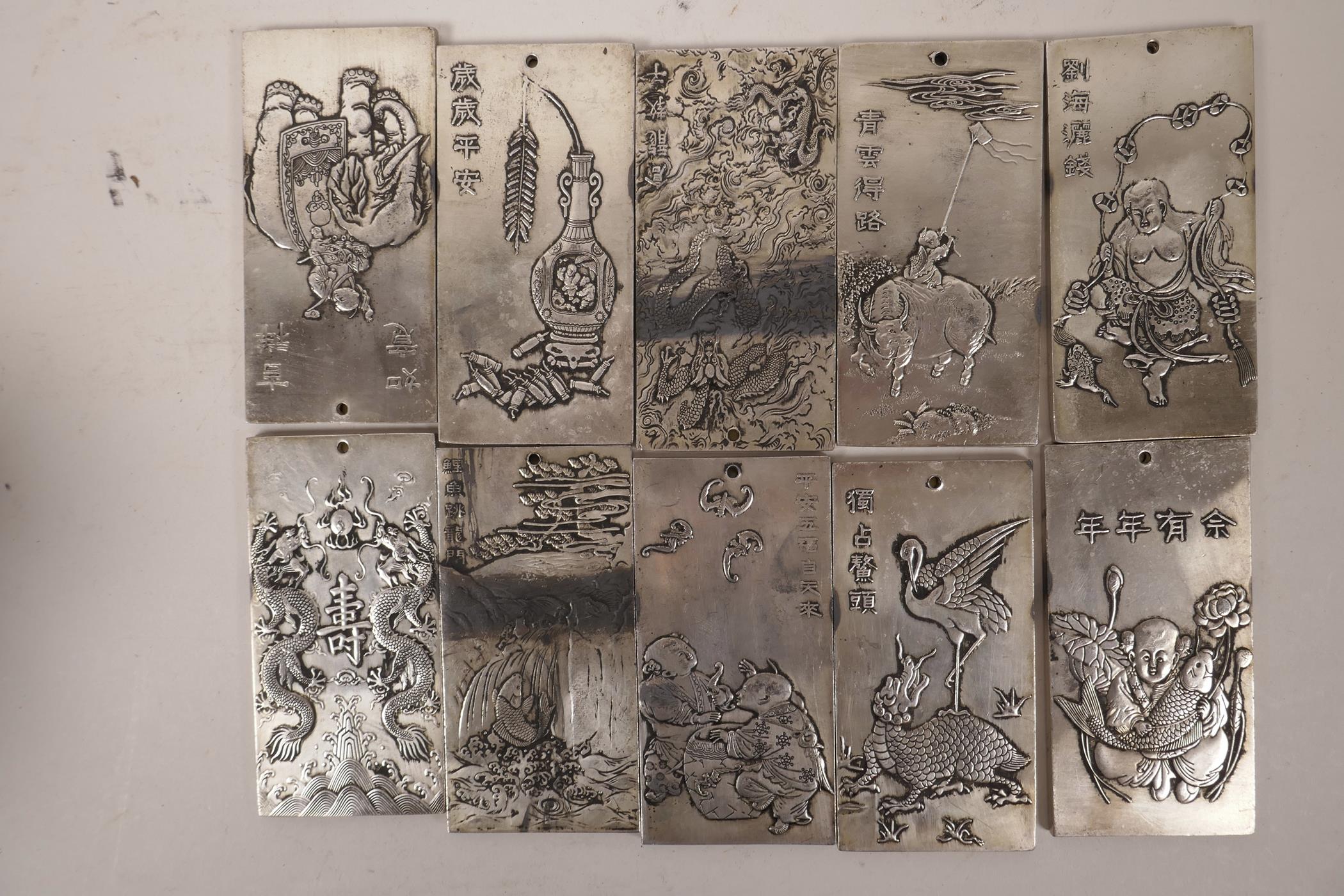 Ten Chinese white metal scroll weights with embossed decoration of figures and mythical beasts,