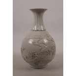 A Chinese cream ground porcelain pear shaped vase with raised decoration of cranes in a landscape,