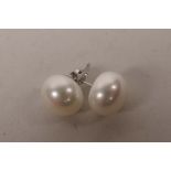 A pair of cultured pearl stud earrings with silver posts