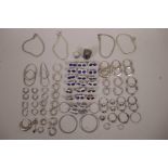 A large collection of silver and white metal hoop and stud earrings set with semi-precious stones