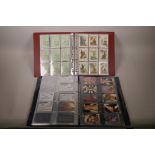 An album of assorted playing card sets together with an album of 1990s telephone cards including