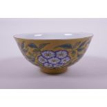 A Chinese yellow ground porcelain rice bowl with polychrome enamelled floral decoration, 4 character
