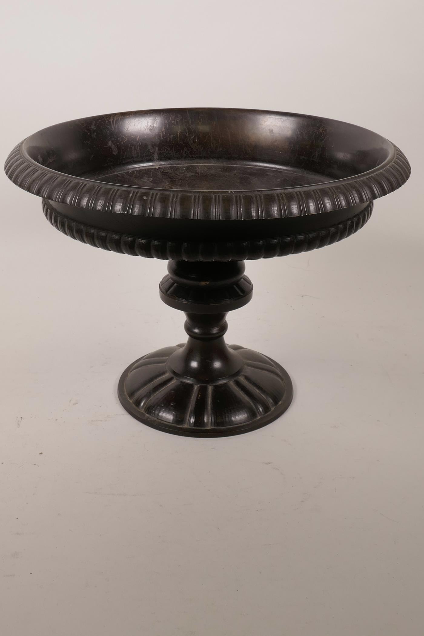 A bronze bowl of classical form, raised on a turned column, 11" diameter x 8" high