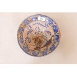 A Middle Eastern glazed terracotta bowl, decorated with a warrior on horseback, 9" diameter